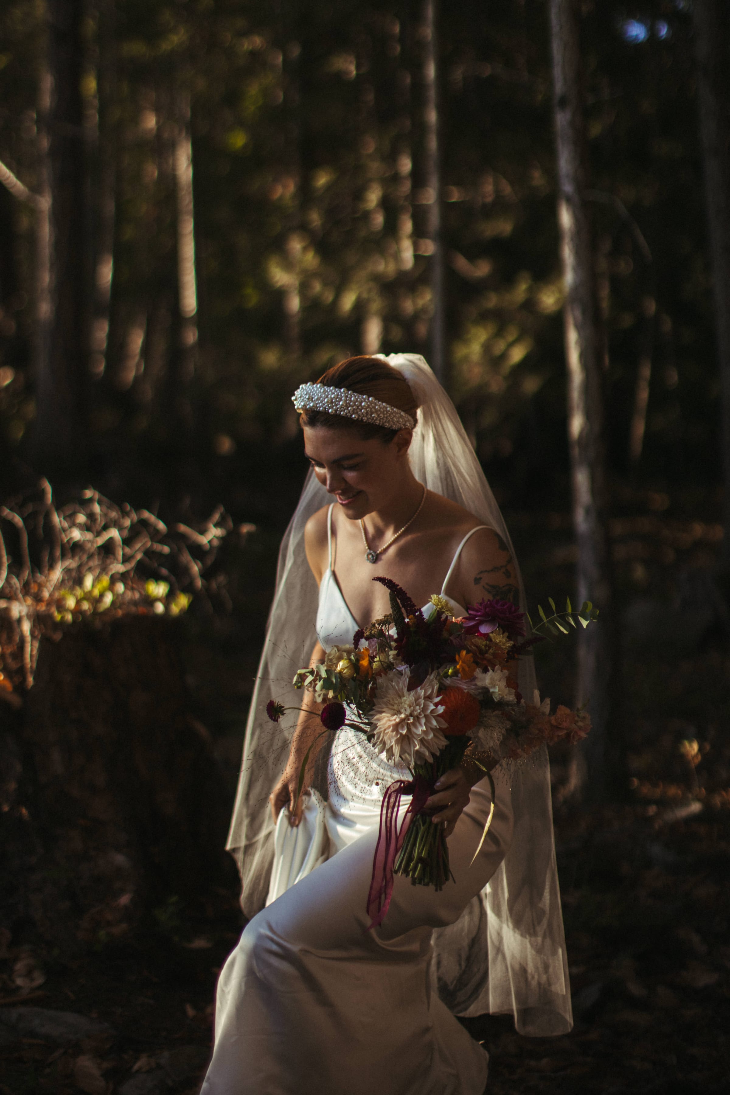 Bride with bouquet in the forest